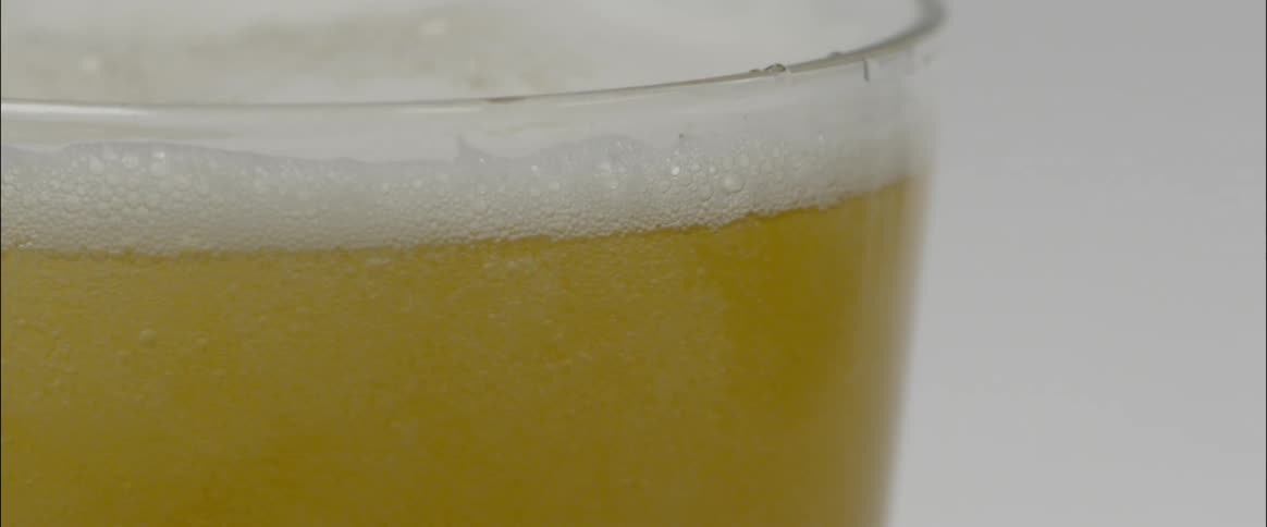 Bubbles rise to the top as beer is poured in a glass
