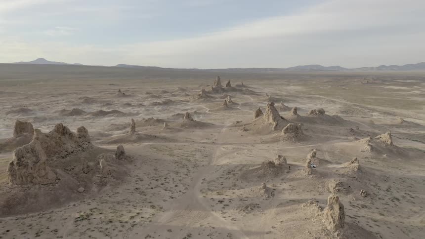 Large spiked rock formations in a desert terrain