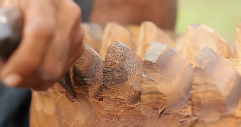 Man carving wood block
