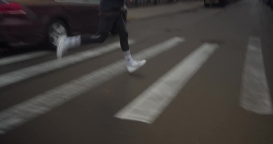 Man jogs through crosswalk on foggy day