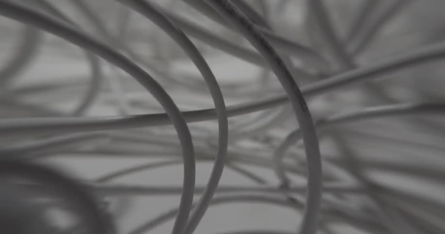 Skimming close through tangled white tubing on flat white surface