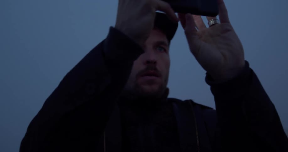 A man takes a picture with a cell phone