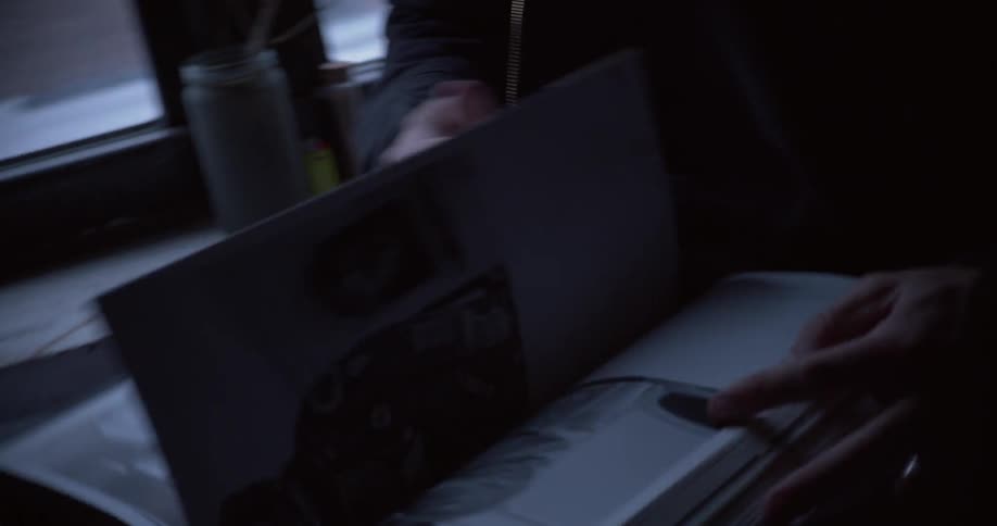 A person flips through pages in a book