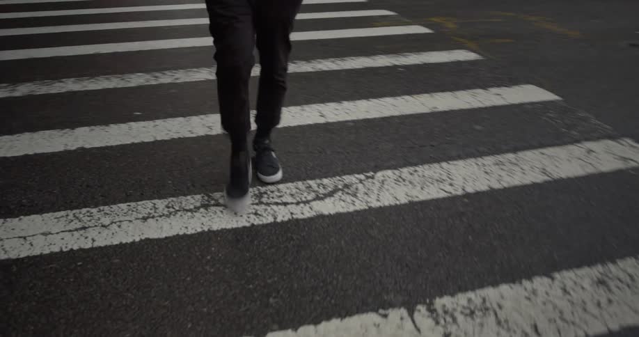 A person using a crosswalk to cross the street