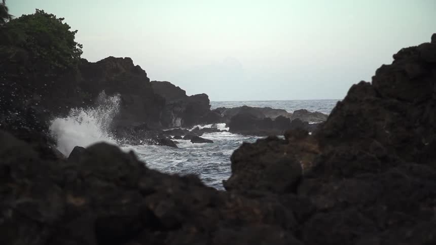 Waves crashing again rocky shore