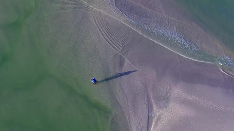 Aerial view of a person fishing by the water