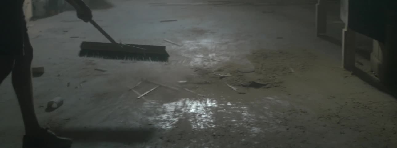A person sweeps the floor