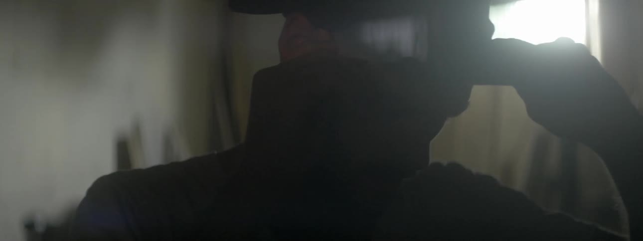 Man removes hat and rubs head then replaces hat on head
