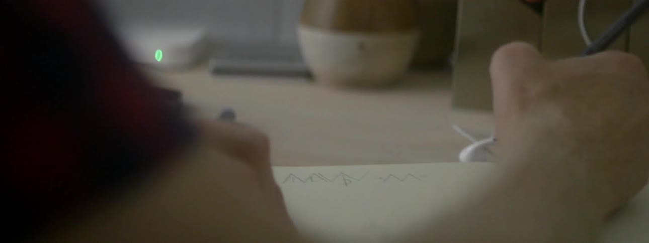 Person drawing on a sheet of paper