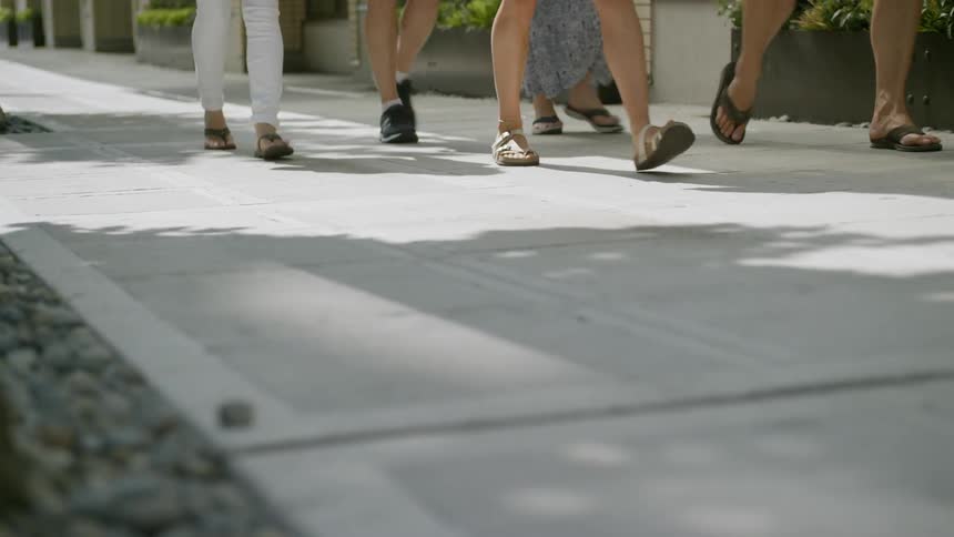Many people walk the sidewalk