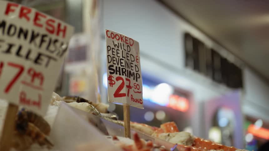Man browses through seafood shop display