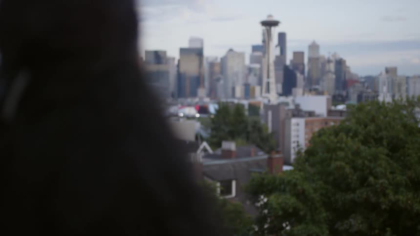 A woman looks at seattle from a distance