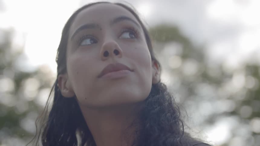 A beautiful woman stares into the sky