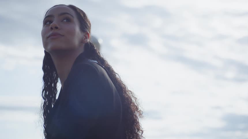 The woman is looking over her shoulder
