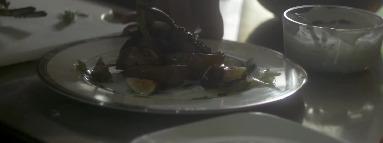 A person adjusting a plate of food