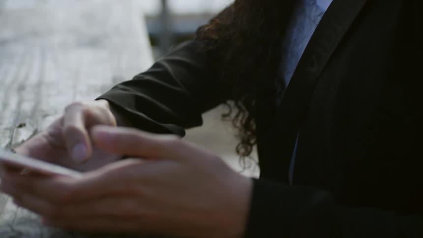 A portrait of a woman texting with her smartphone