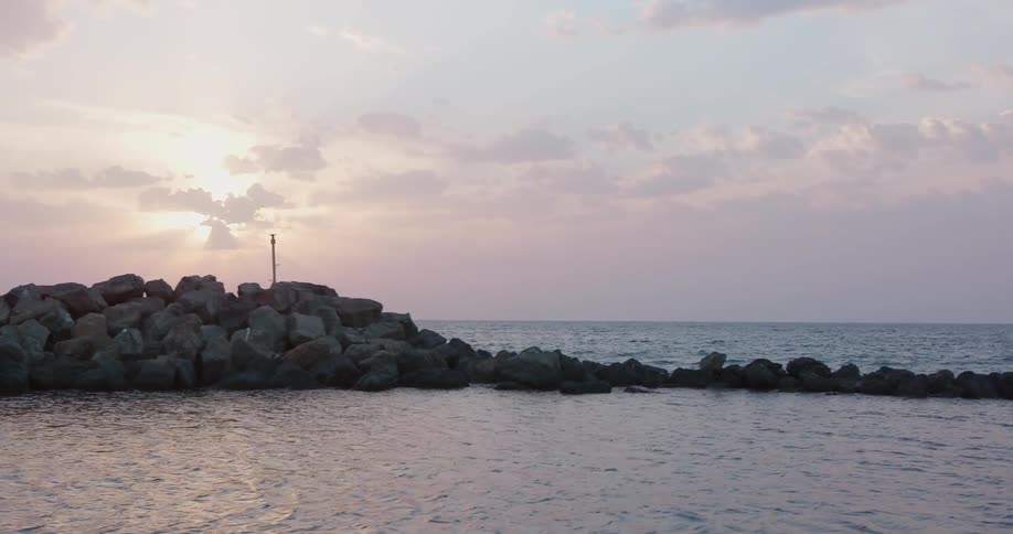 Waves are moving towards the coast covered in rocks