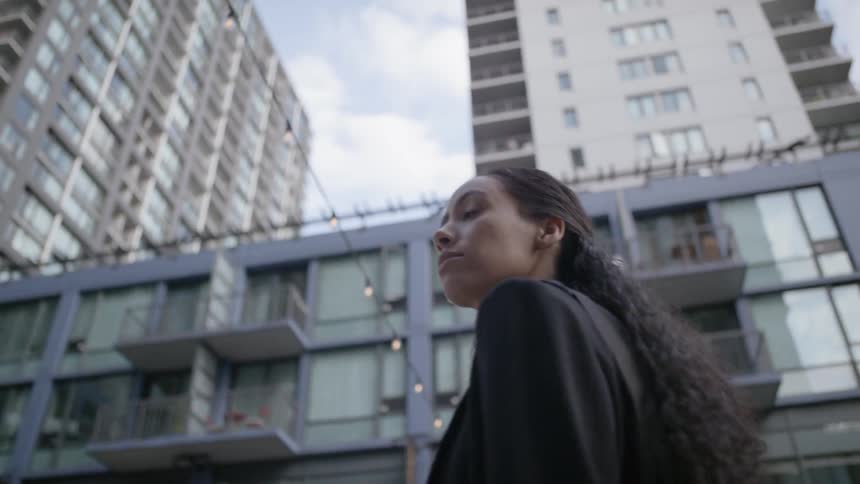 A woman is walking in a downtown city