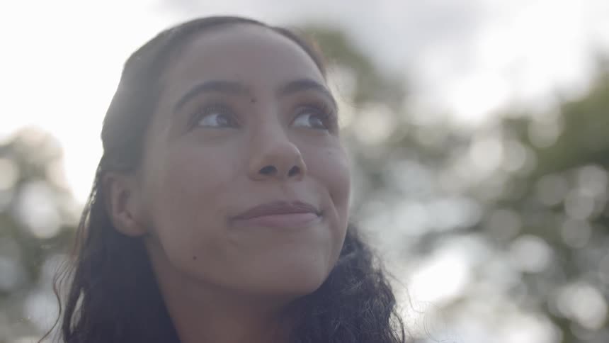 Woman smiles and looks up