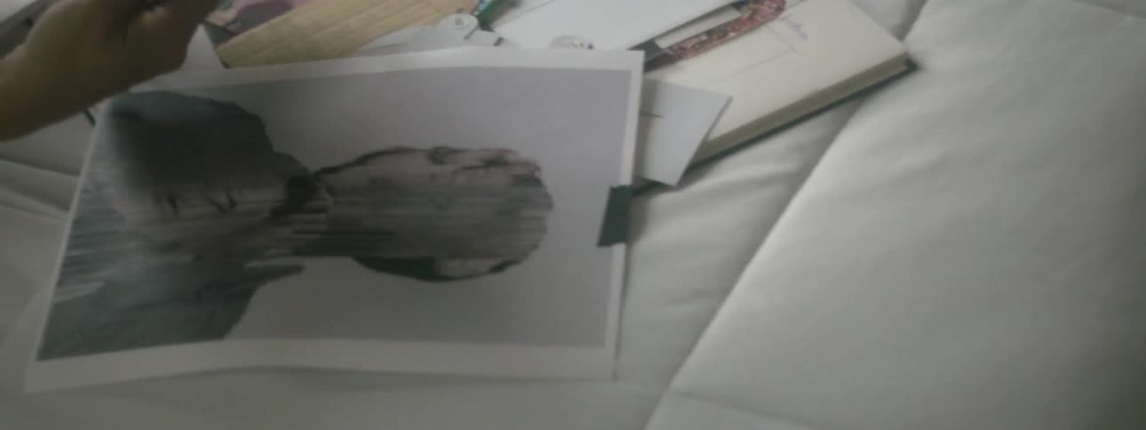Woman organizing pictures and fabric on a table