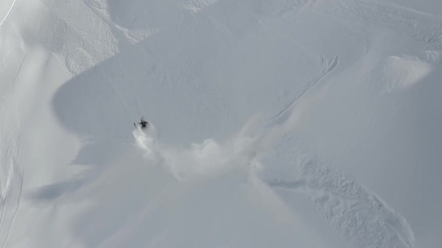 Birds eye view view of snowboarder on a snowy mountain