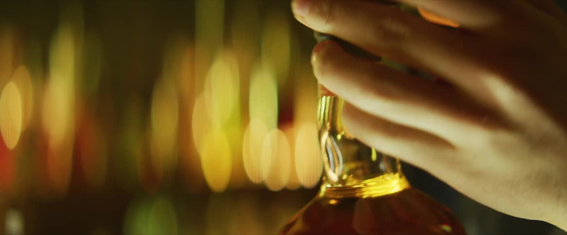A person peels the seal off the bottle