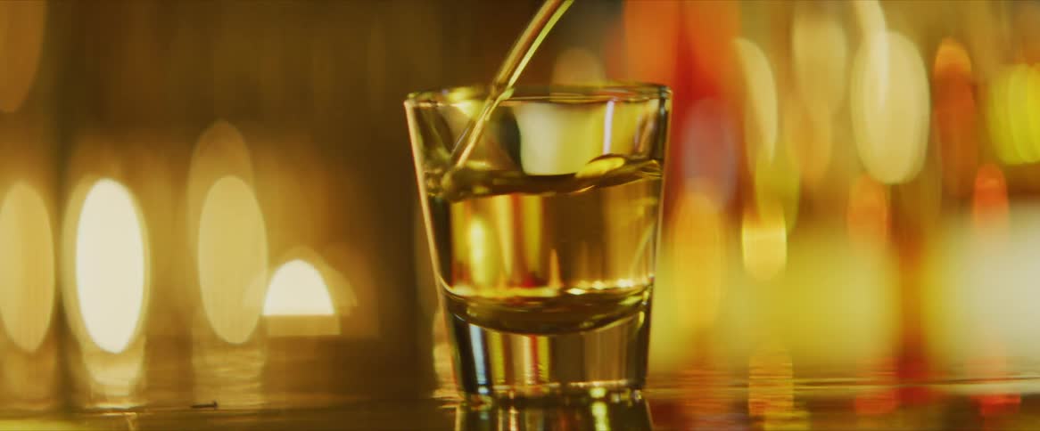 Liquid is poured into a shot glass