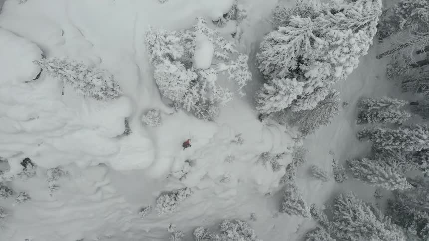 An aerial footage of man skiing on the slope mountain