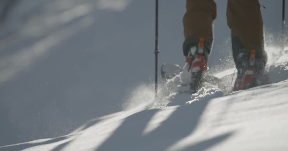 A person is hiking through the deep snow