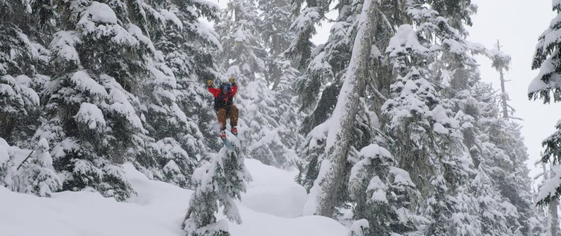 A person is skiing down a mountain in snow