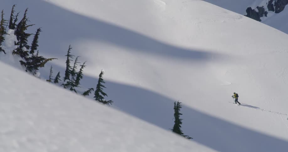 A man walking on the snowy hill