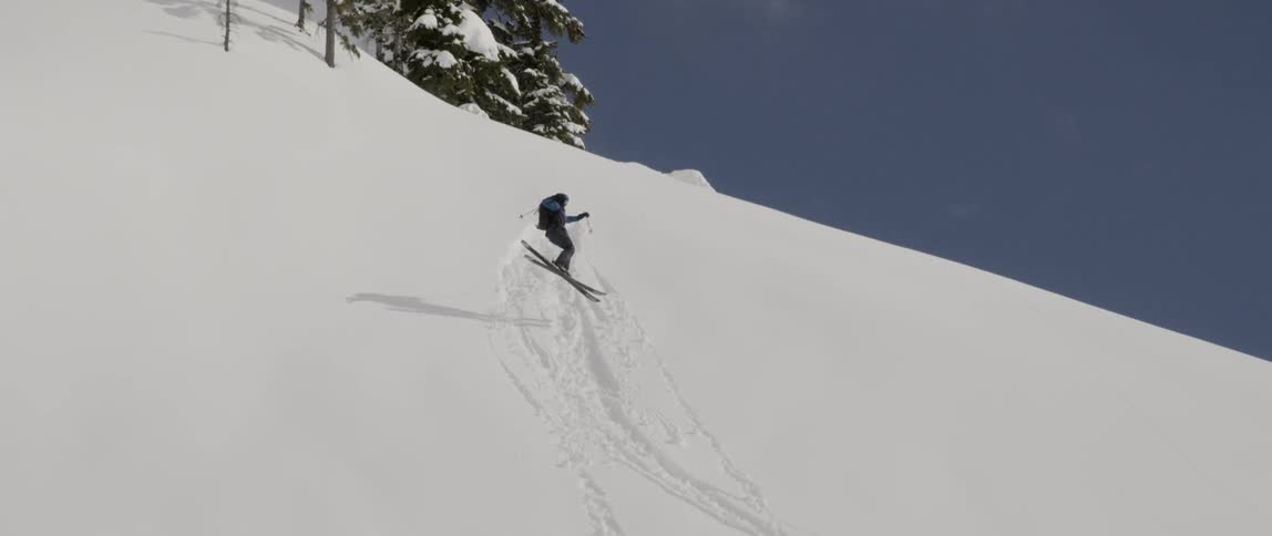 A person jumps off the hill on his skis