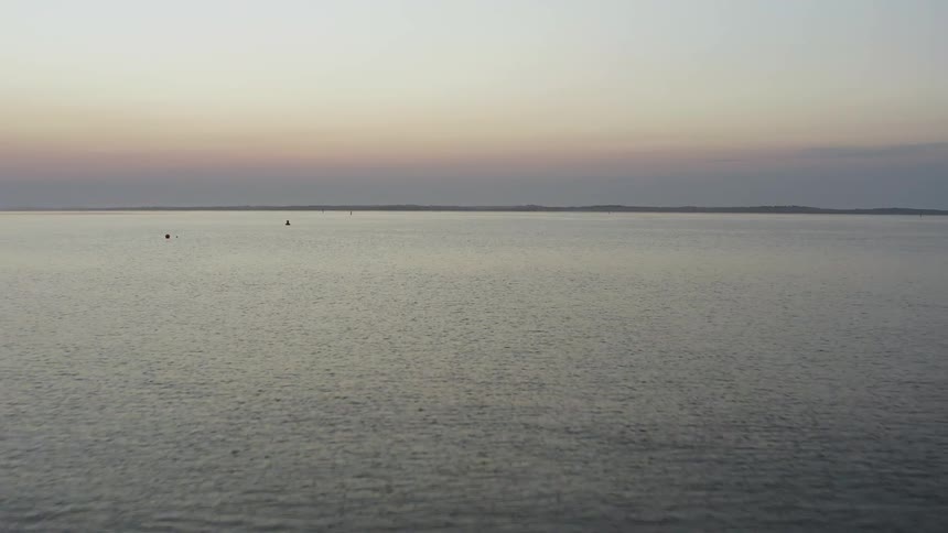 A scenery of a wide ocean at the dawn