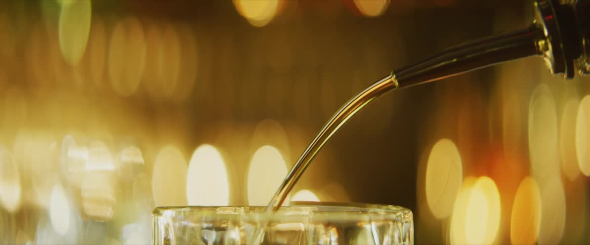 Liquor poured from spout into glass