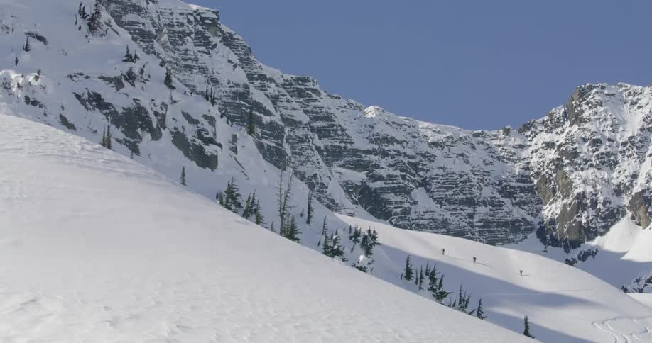 Snow covered slope near mountain range on winter