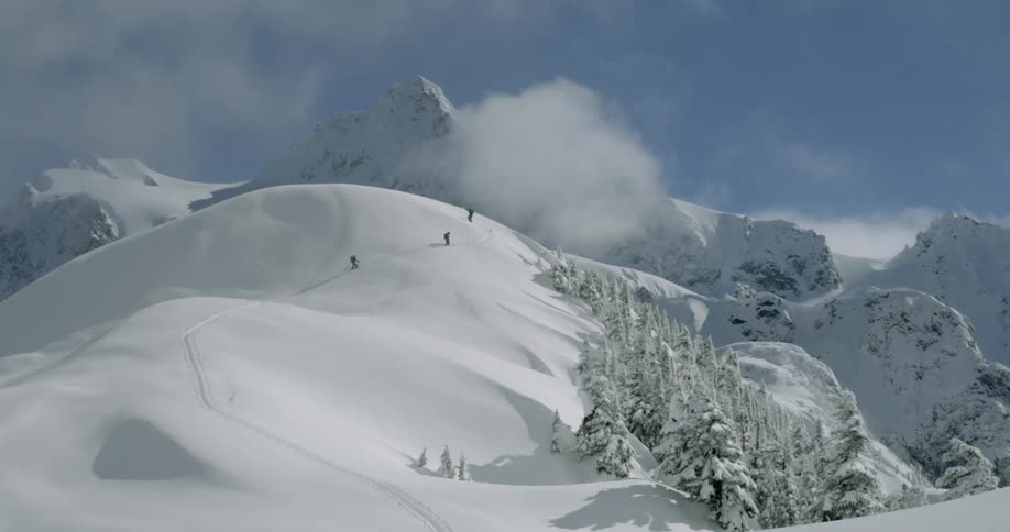 People are climbing up a mountain in winter