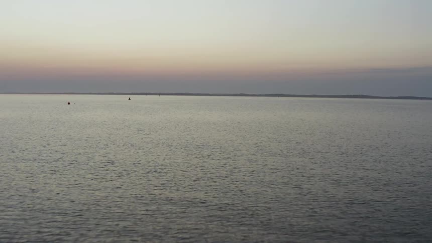 A scenery of an ocean at the dawn