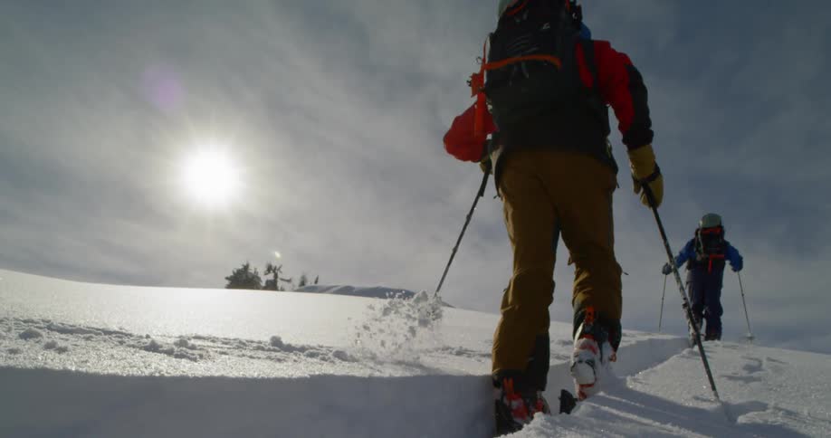 Cross country skiers trekking through the snow in the mountains