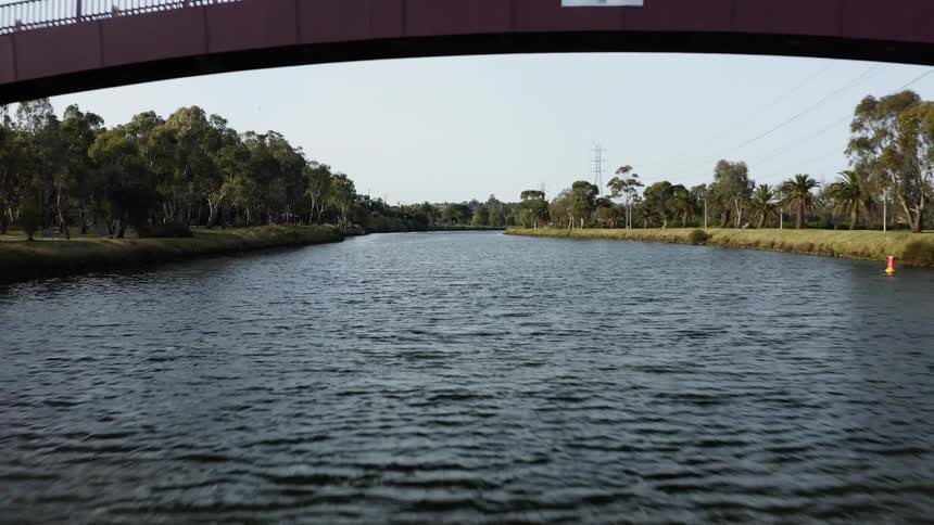A footage of a river below the bridge on the rural area