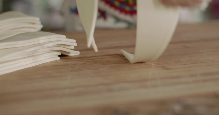 A woman preparing dough for the meal