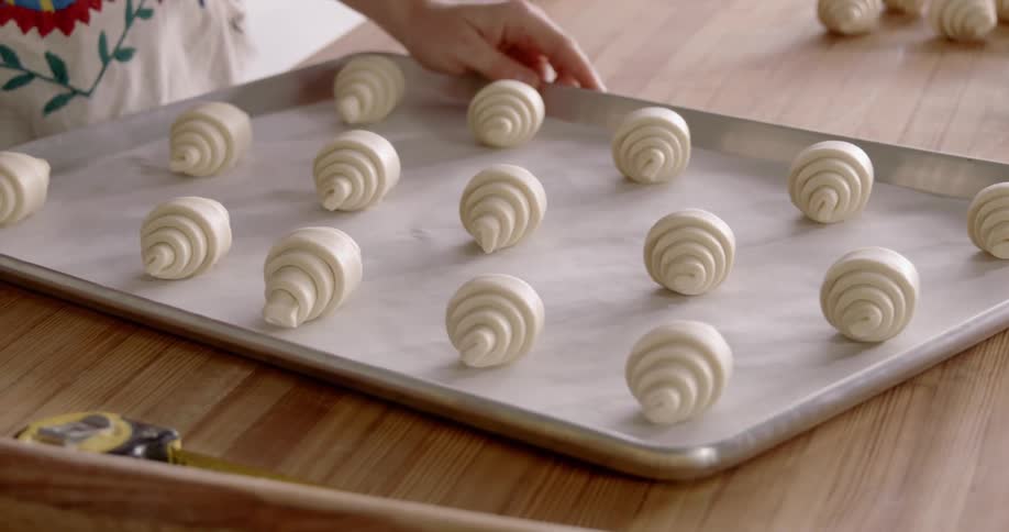 Crescent rolls lined up on a baking sheet