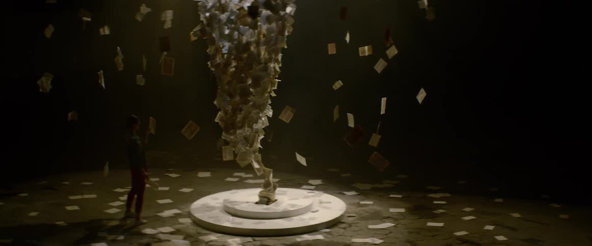 A person is walking around a room and objects are floating