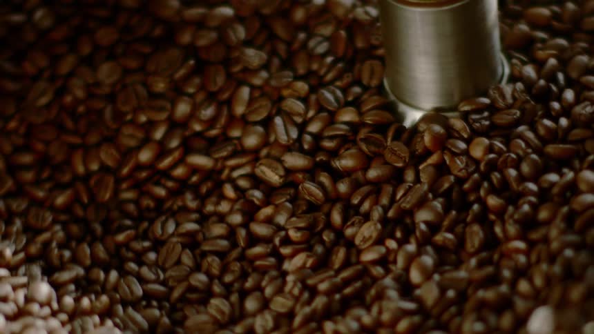A mixer stirs coffee beans