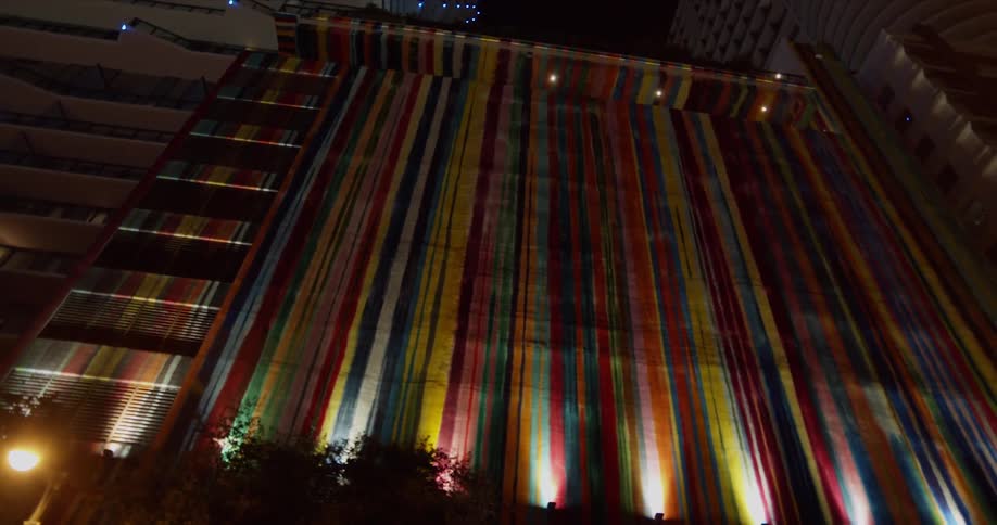 The side of the building is painted in raindow colors