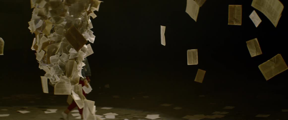 A person walks near floating book pages