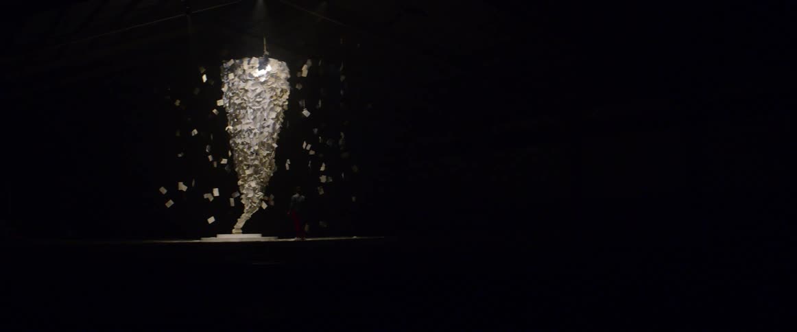 Book pages float and form a conical shape as part of a piece of artwork