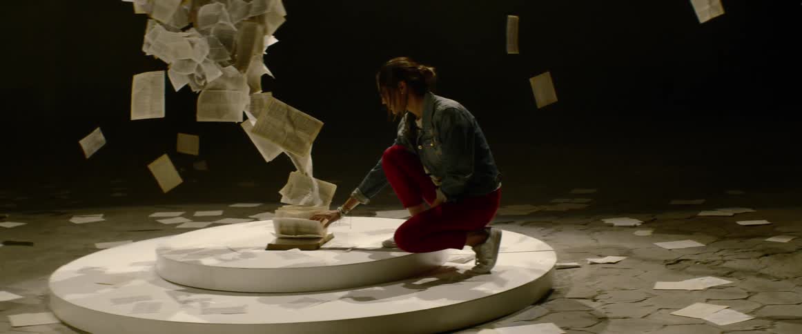 An artist turns the page of an artistically blown up book