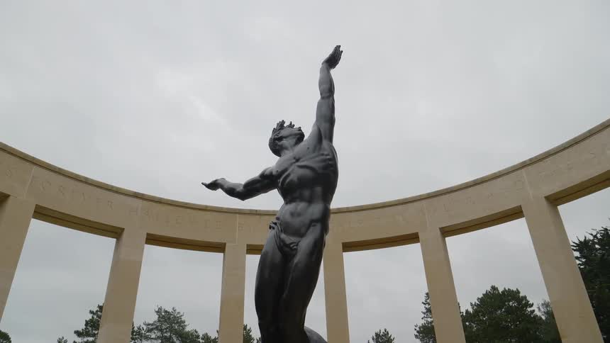 Bronze statue of nude athlete reaching to grasp the sky