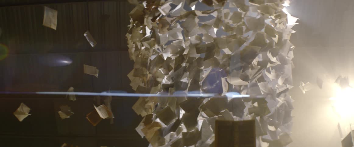A sculpture of paper floating with creative lighting