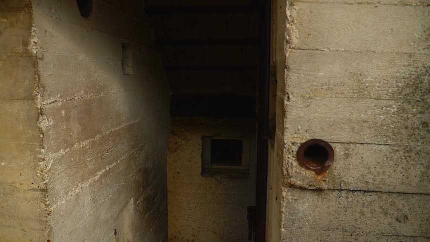 Pipes and a hole in stone walls and a narrow opening leading to a window